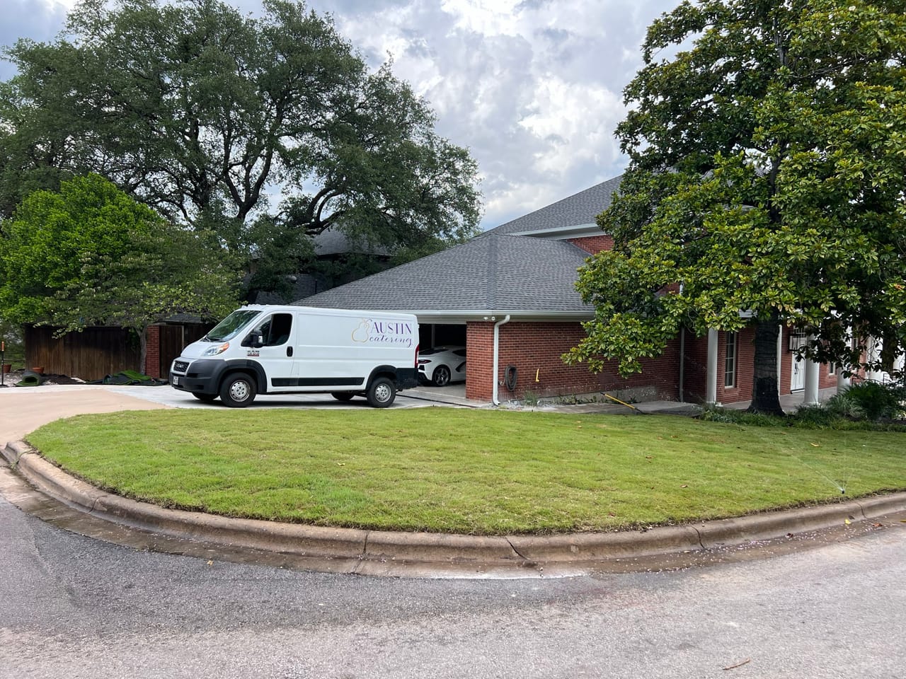 White work van parked at a mowed commercial building lawn in Pflugerville, TX