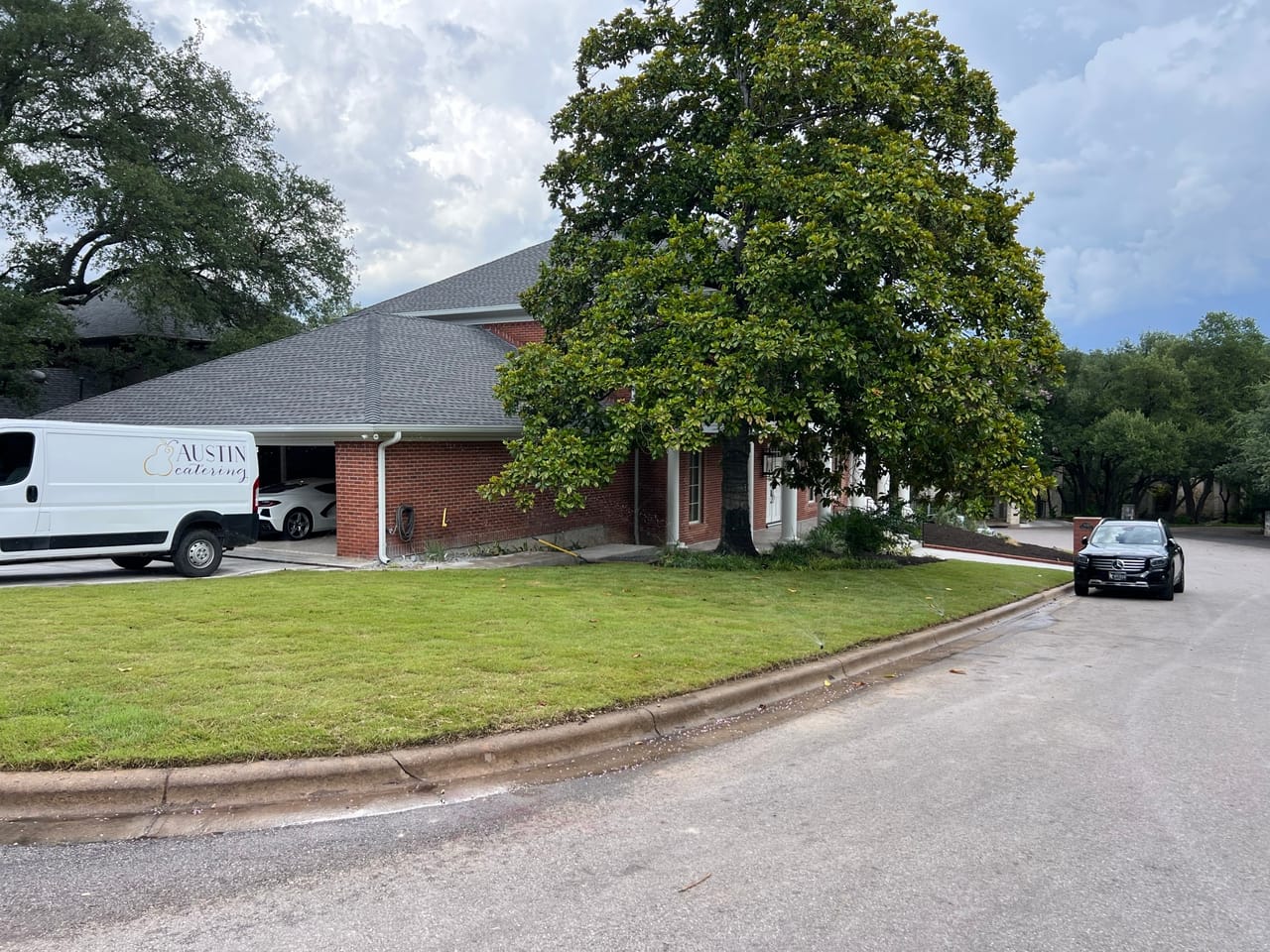Work van on a maintained lawn under large shade trees in San Marcos, TX