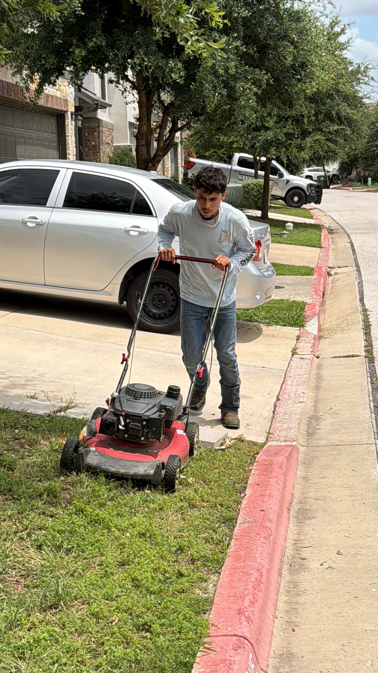 Corral Bros crew mowing a residential lawn in Central Texas