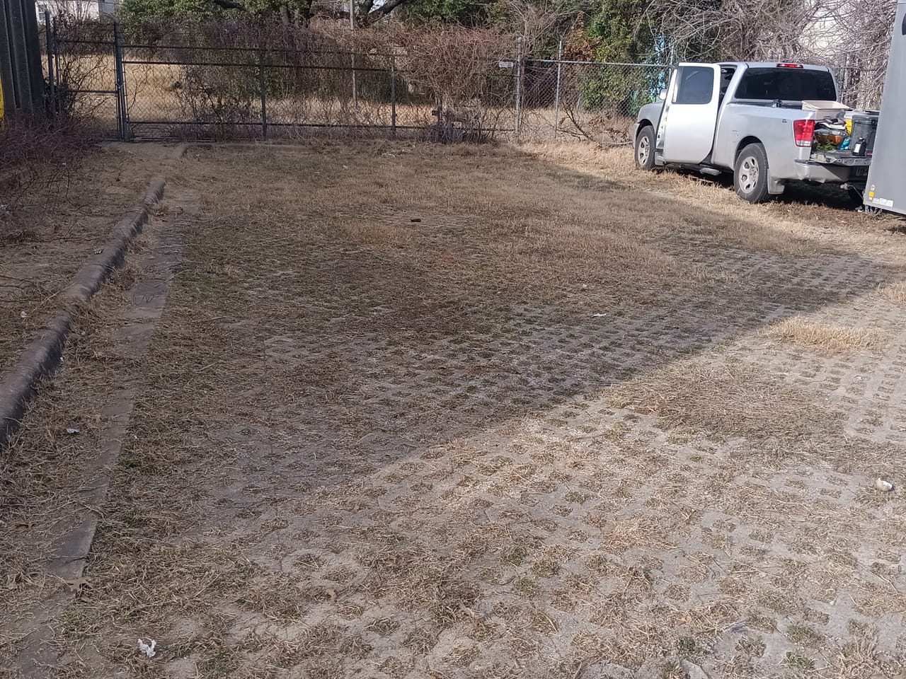 Freshly graded dirt yard with erosion grid pattern beside a driveway in Leander, TX
