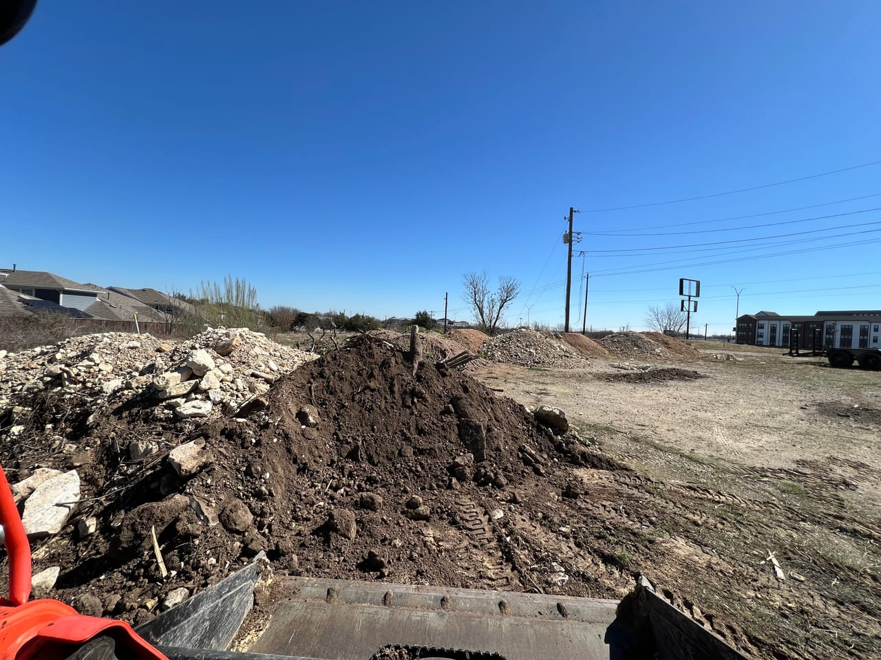 Pile of dirt and broken concrete on a cleared lot in Austin, TX