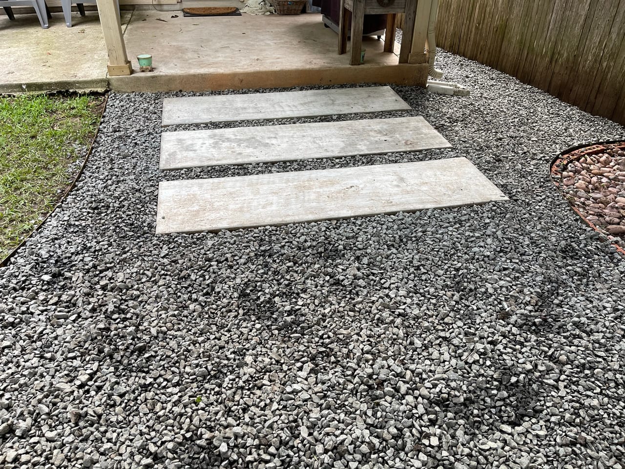 Concrete stepping pavers set into a gray gravel walkway in Georgetown, TX
