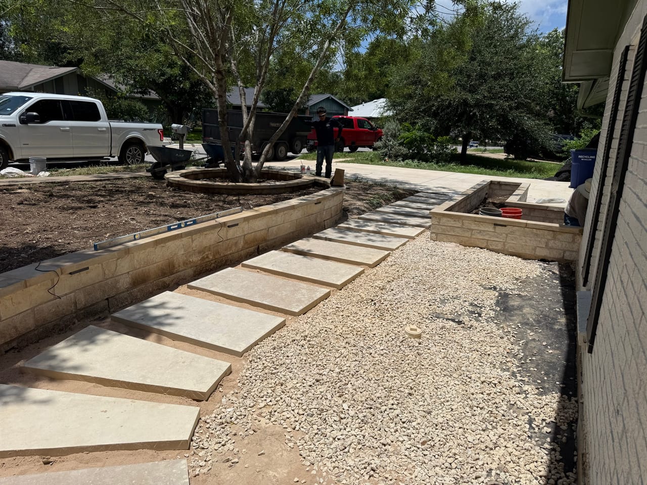 Long curved flagstone walkway with pea gravel border beside the house in Central Texas