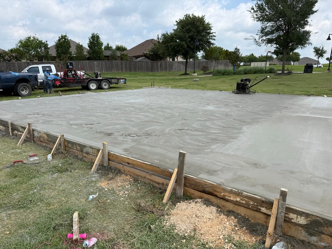 Smooth finished concrete slab still in its wood forms in a park in Central Texas