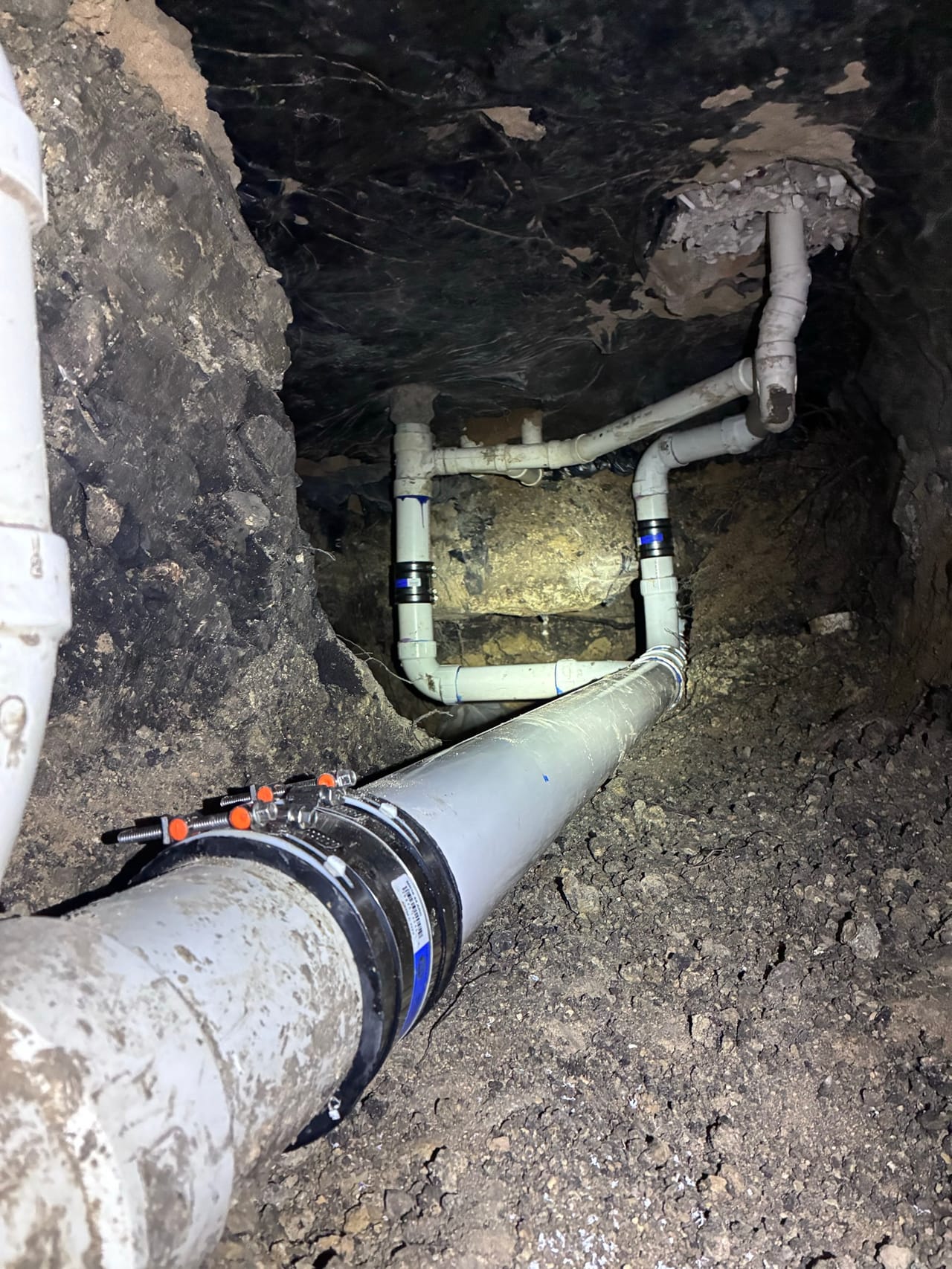 New PVC repair with couplings and clamps in an open trench in Round Rock, TX