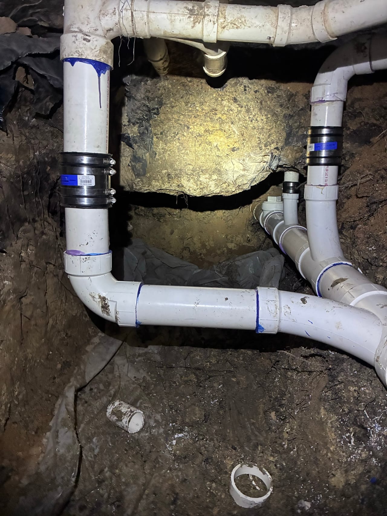 PVC manifold with valves and fittings assembled in a rock trench in Kyle, TX