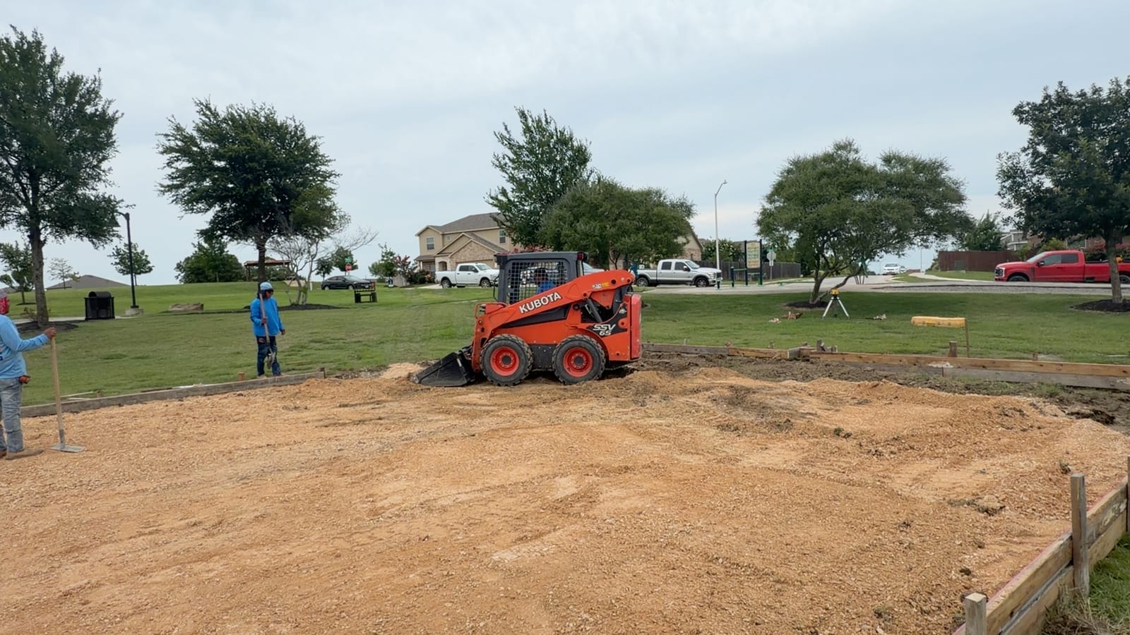 Corral Bros crew grading and shaping a site with a skid steer in Central Texas