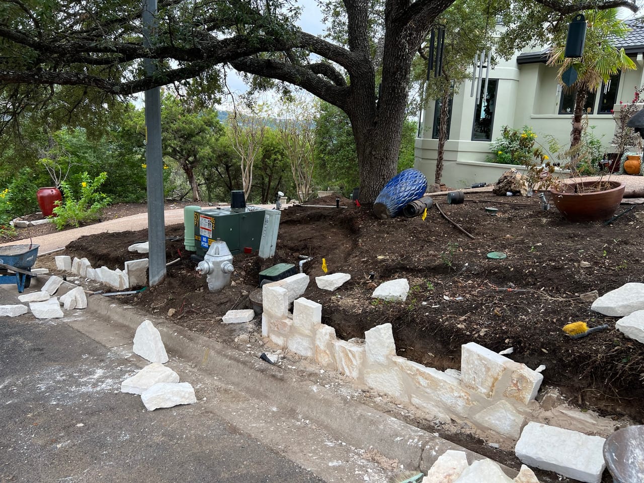 New bed under a huge oak with limestone blocks and fresh soil in Georgetown, TX