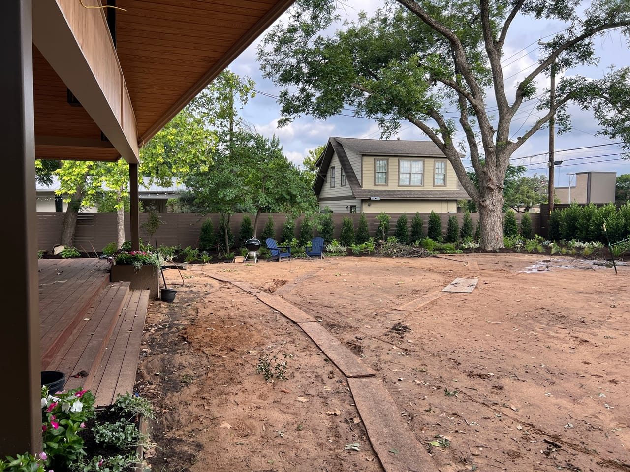 Steel edged curved beds and hedges viewed from under a patio in Schertz, TX