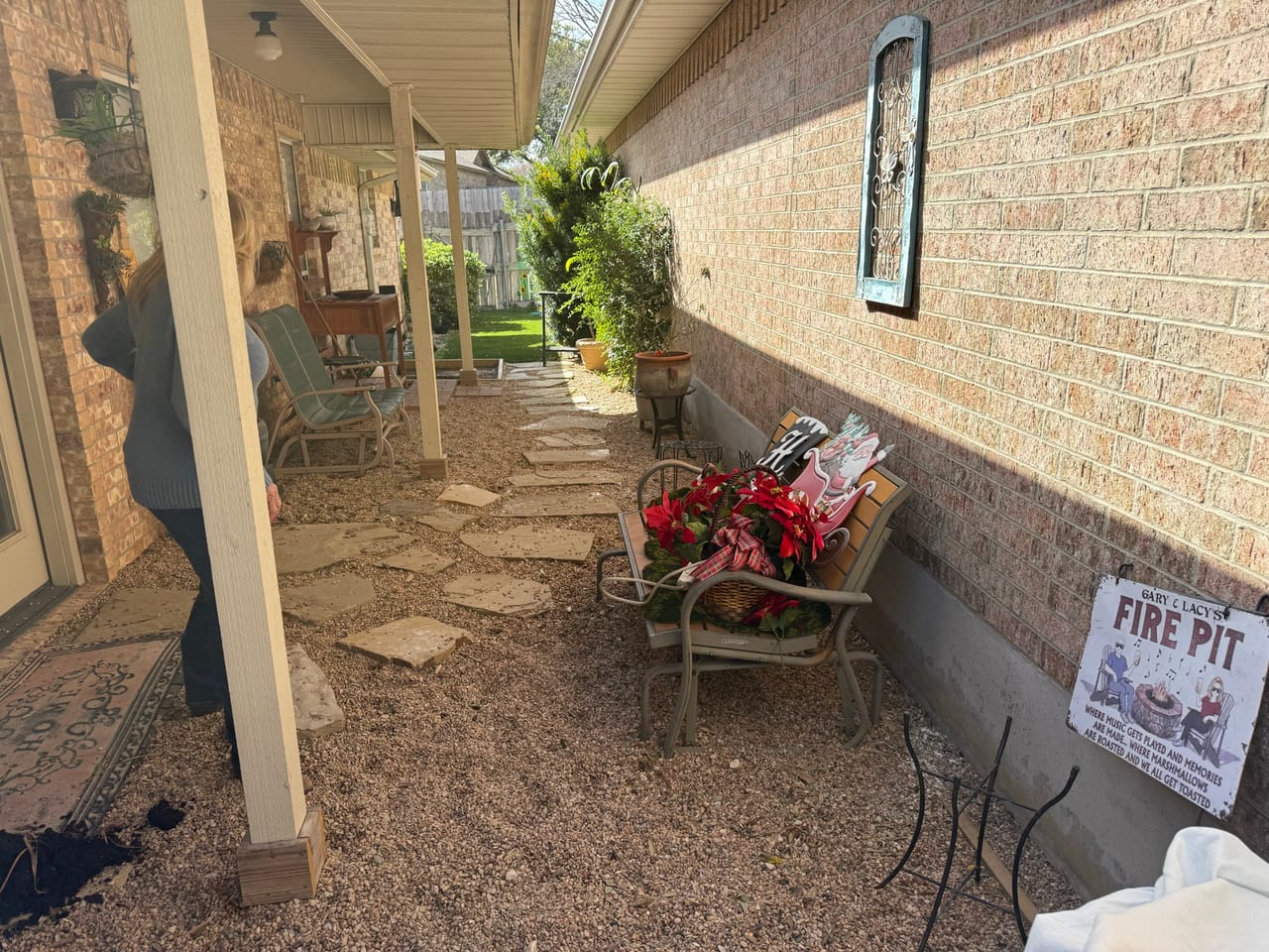 Brick covered patio with gravel floor, patio chairs and fire pit sign in Pflugerville, TX