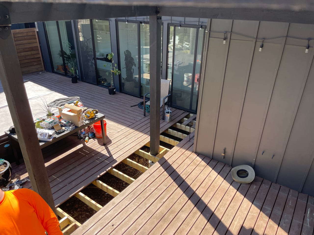 Deck framing under construction at a modern glass walled building in Central Texas