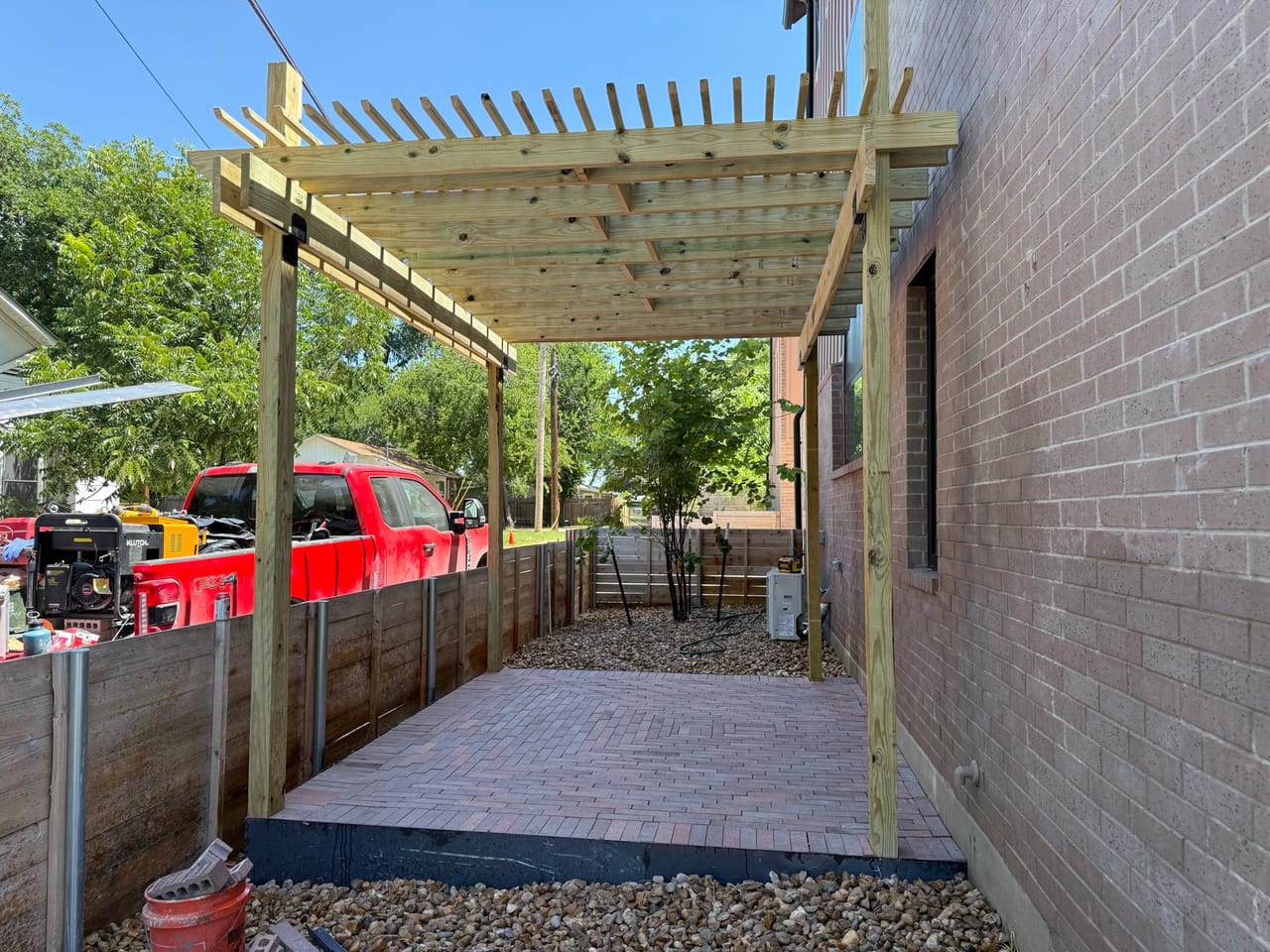 Finished pergola and brick paver path with gravel edging both sides in Round Rock, TX