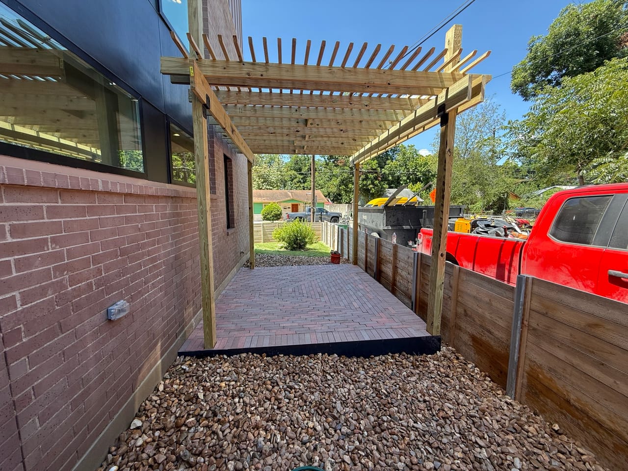 Pergola over a new brick paver walkway beside a brick wall in Georgetown, TX