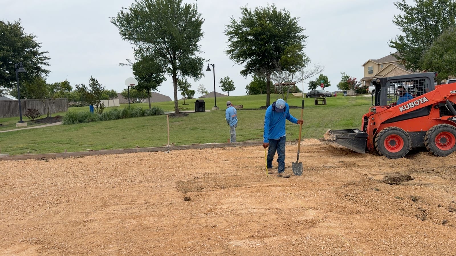 Corral Bros crew hand-grading a site with shovels in Central Texas