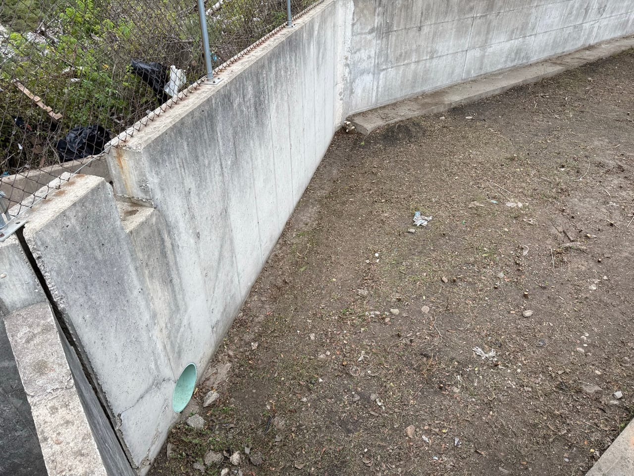 Cleaned concrete detention basin with bare graded bottom and clean walls in Austin, TX