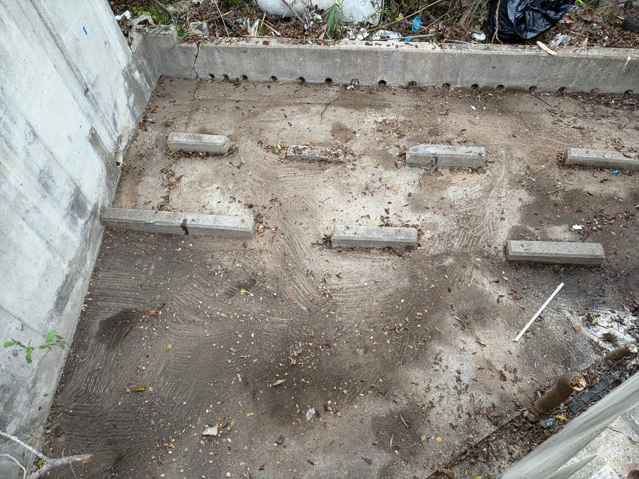 Concrete basin floor with baffle blocks after silt and debris removal in Kyle, TX